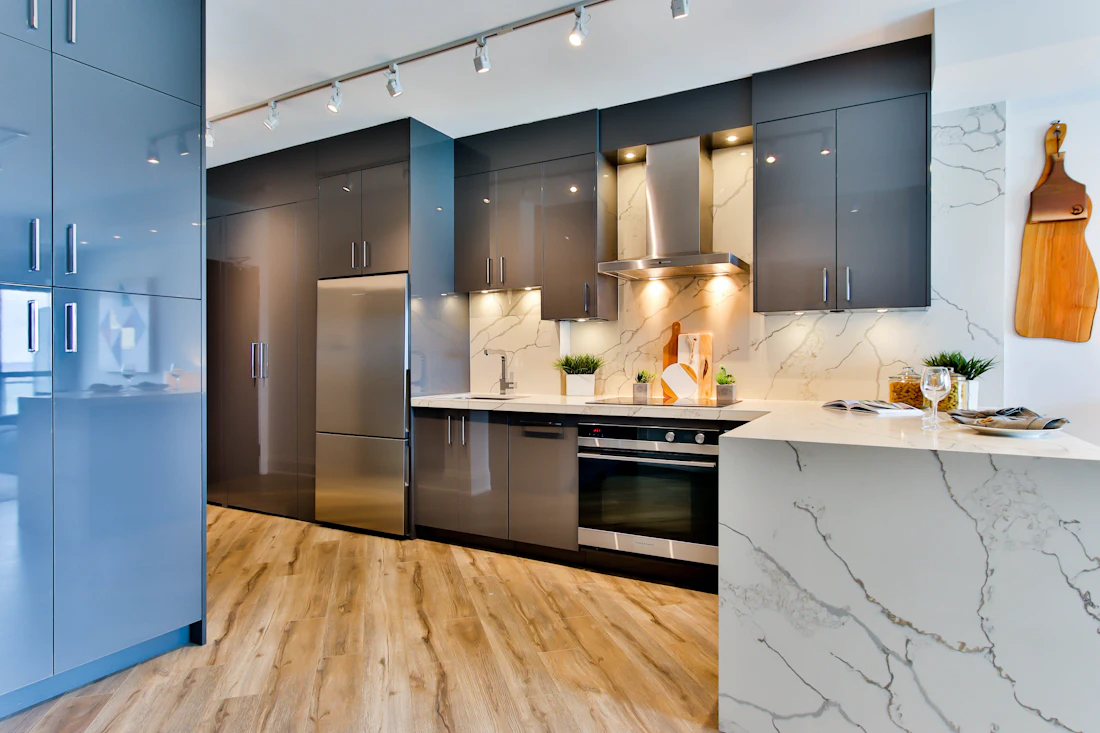 Remodeled kitchen with dark cabinets and stone counters
